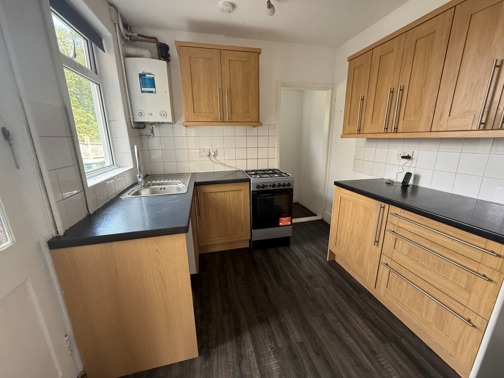 Lot: 143 - TWO-BEDROOM SEMI-DETACHED HOUSE WITH DRIVEWAY - First view of tiled kitchen with boiler and pantry